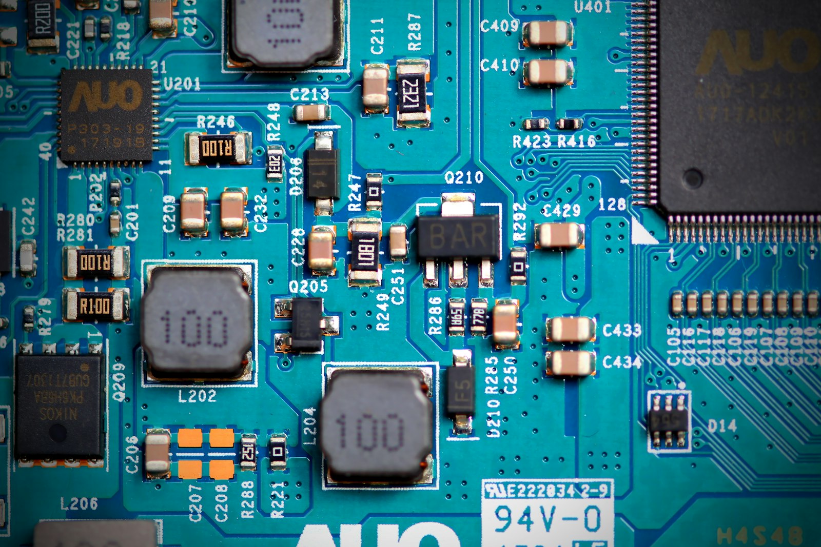 Close-up of a printed circuit board in blue tones